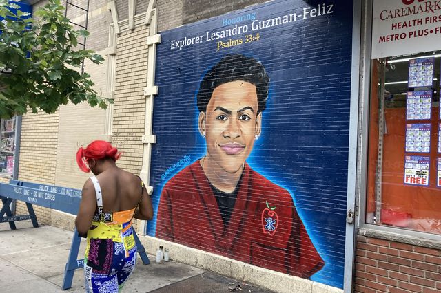 A woman passes by a mural of Lesandro Guzman-Feliz, the 15-year-old boy fatally stabbed in the Belmont section of the Bronx in June 2018.